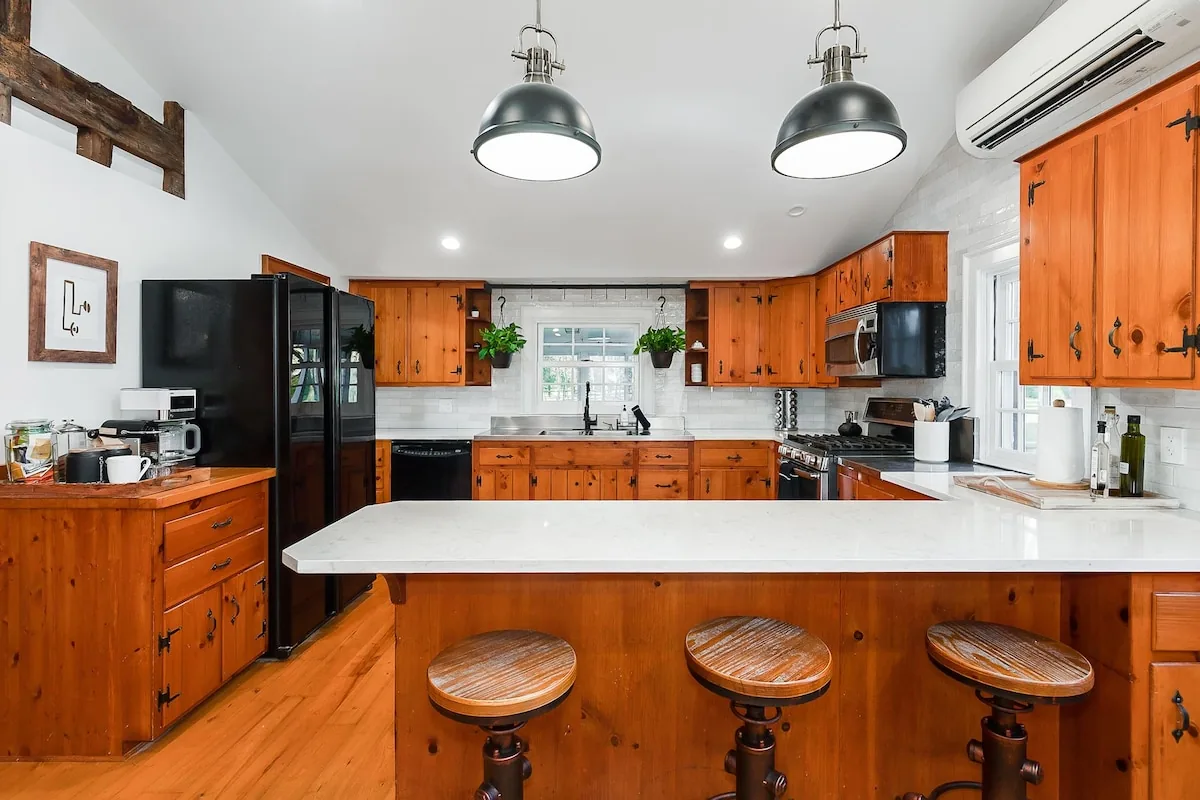 Large farmhouse kitchen with an island and counter seating