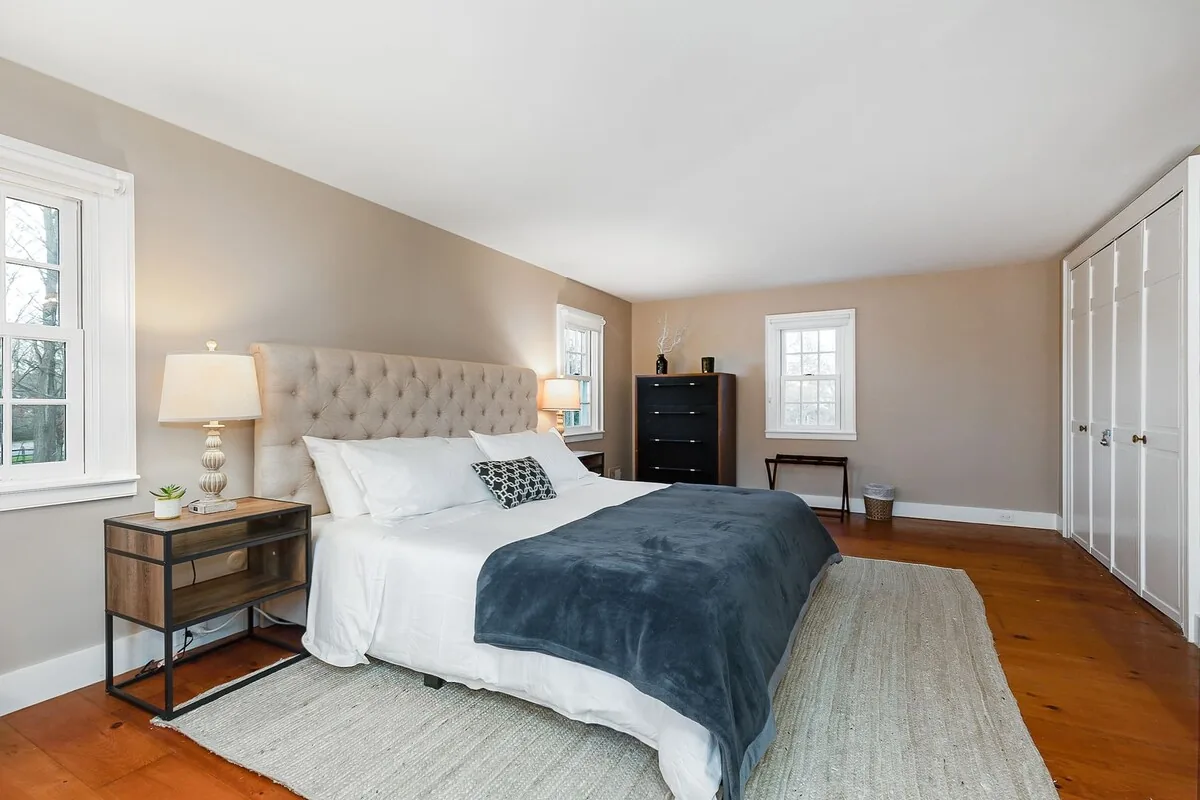 Bedroom with upholstered bed and reading chair