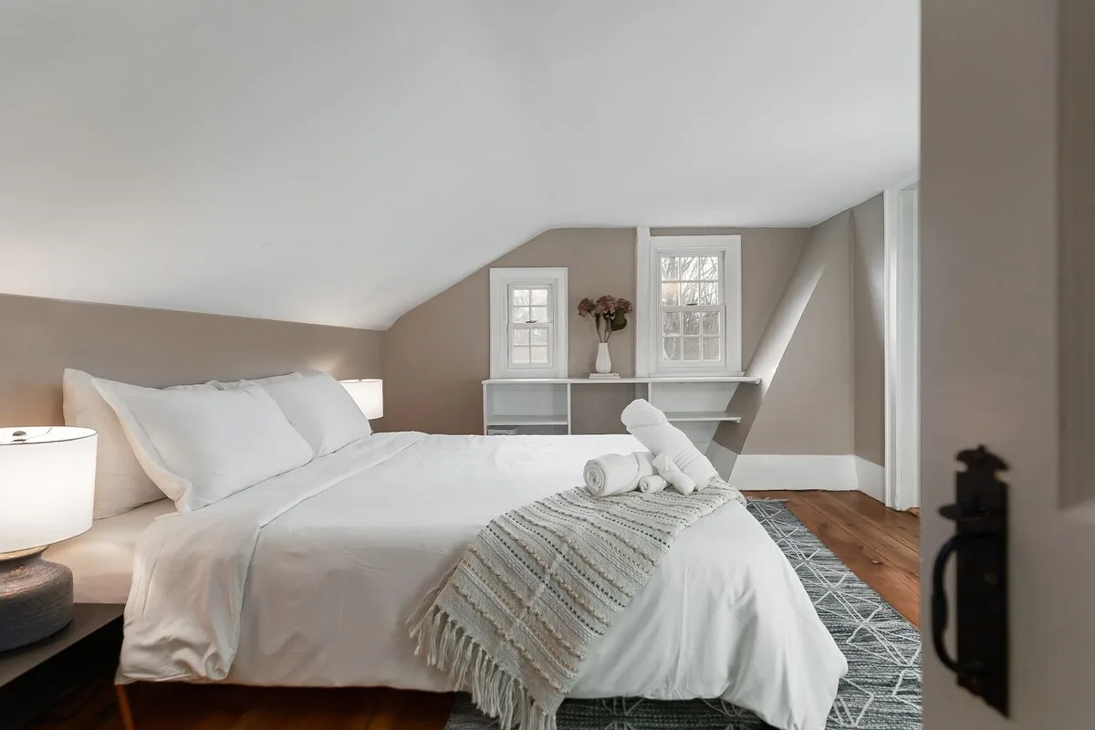 Bedroom with two beds beneath a sloped ceiling
