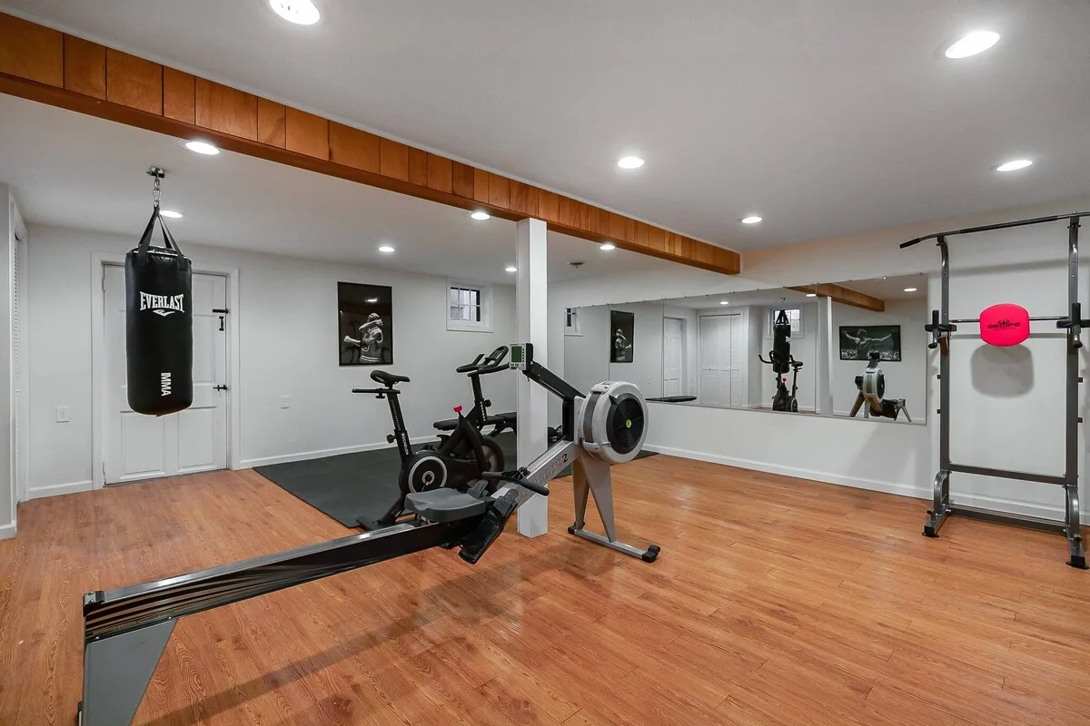 Private home gym with exercise bike, rower, weights and yoga space