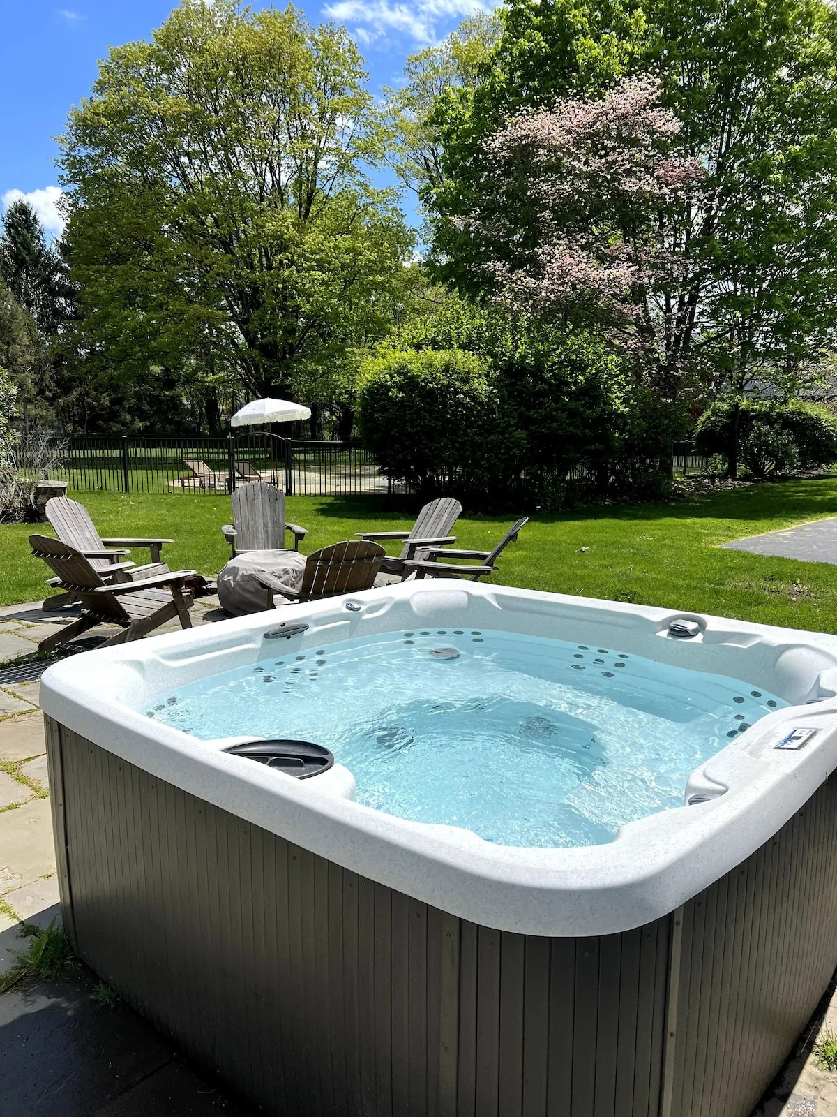 Five-person hot tub overlooking the lawn