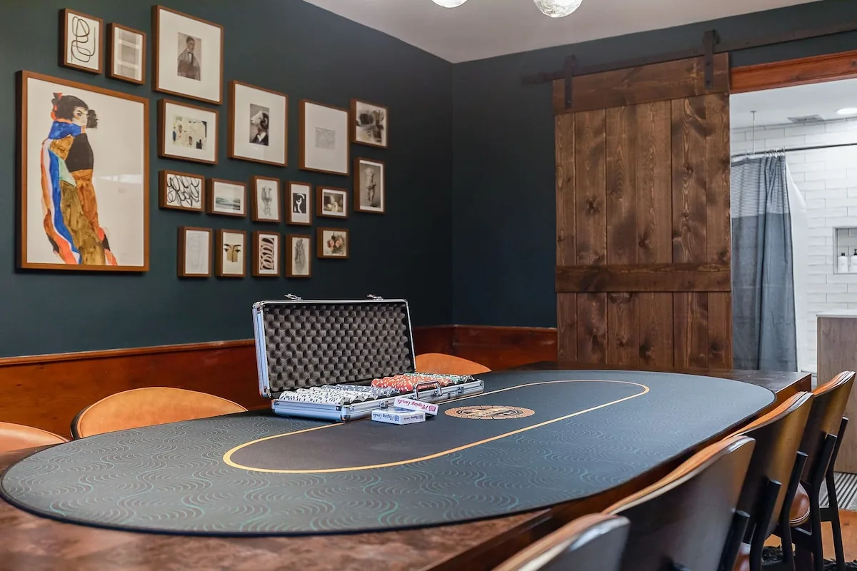 Round game table with cards and dartboard nearby